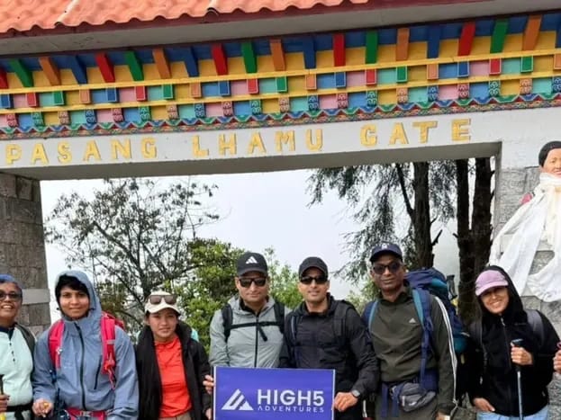 Trekkers holding a High 5 Adventures banner under the Pasang Lhamu Gate in Lukla, May 2026 Trekkers holding a High 5 Adventures banner under the Pasang Lhamu Gate in Lukla, May 2026